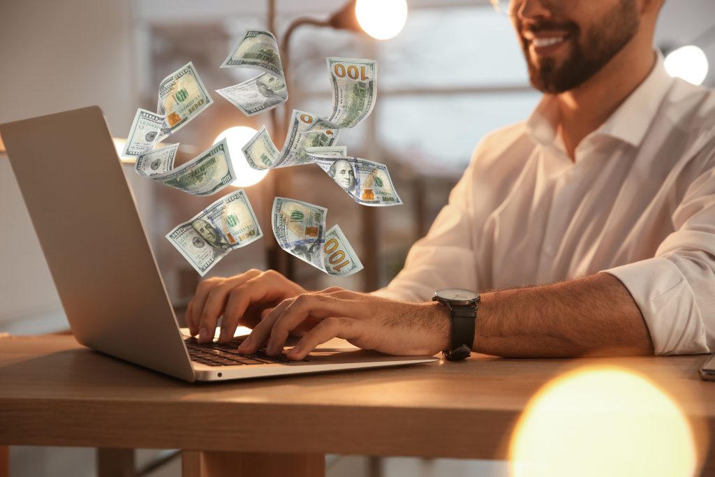 Making money online. Closeup view of man using laptop at table a